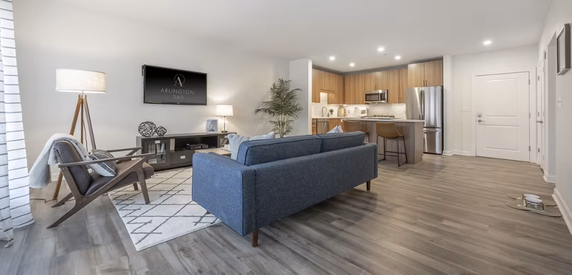 Modern living room with hardwood floors and large windows in Arlington 360 Apartments