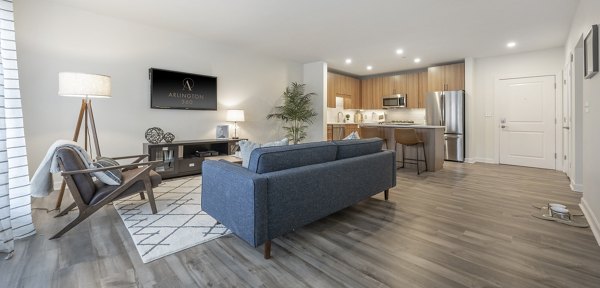 Modern living room with hardwood floors and large windows in Arlington 360 Apartments