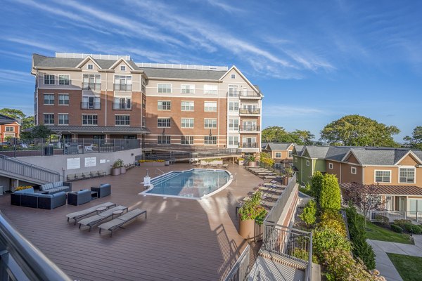 Relaxing pool area at Arlington 360 Apartments with lounge chairs and scenic views