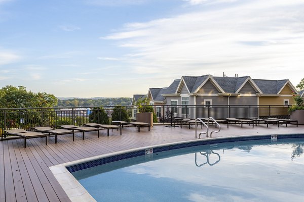 Relaxing outdoor pool surrounded by lush greenery at Arlington 360 Apartments, ideal for leisure and recreation