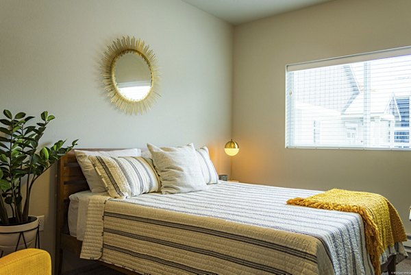 Modern bedroom featuring chic decor and ample natural light at Broadway190 Apartments