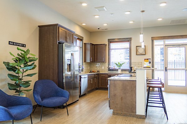 Modern clubhouse with stylish seating and large TV at Broadway190 Apartments