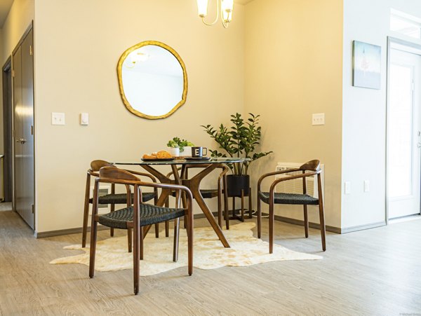 Dining area with modern furnishings and large windows at Broadway190 Apartments luxury residences
