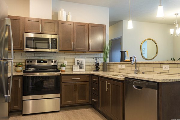 Modern kitchen with stainless steel appliances at Broadway190 Apartments, a Greystar luxury community