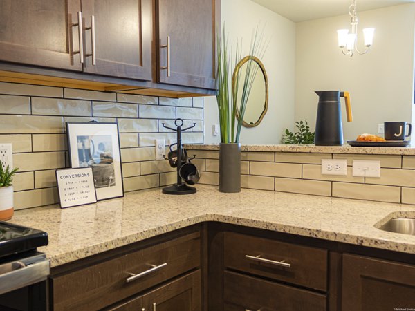 Modern kitchen with sleek cabinetry and stainless steel appliances at Broadway190 Apartments