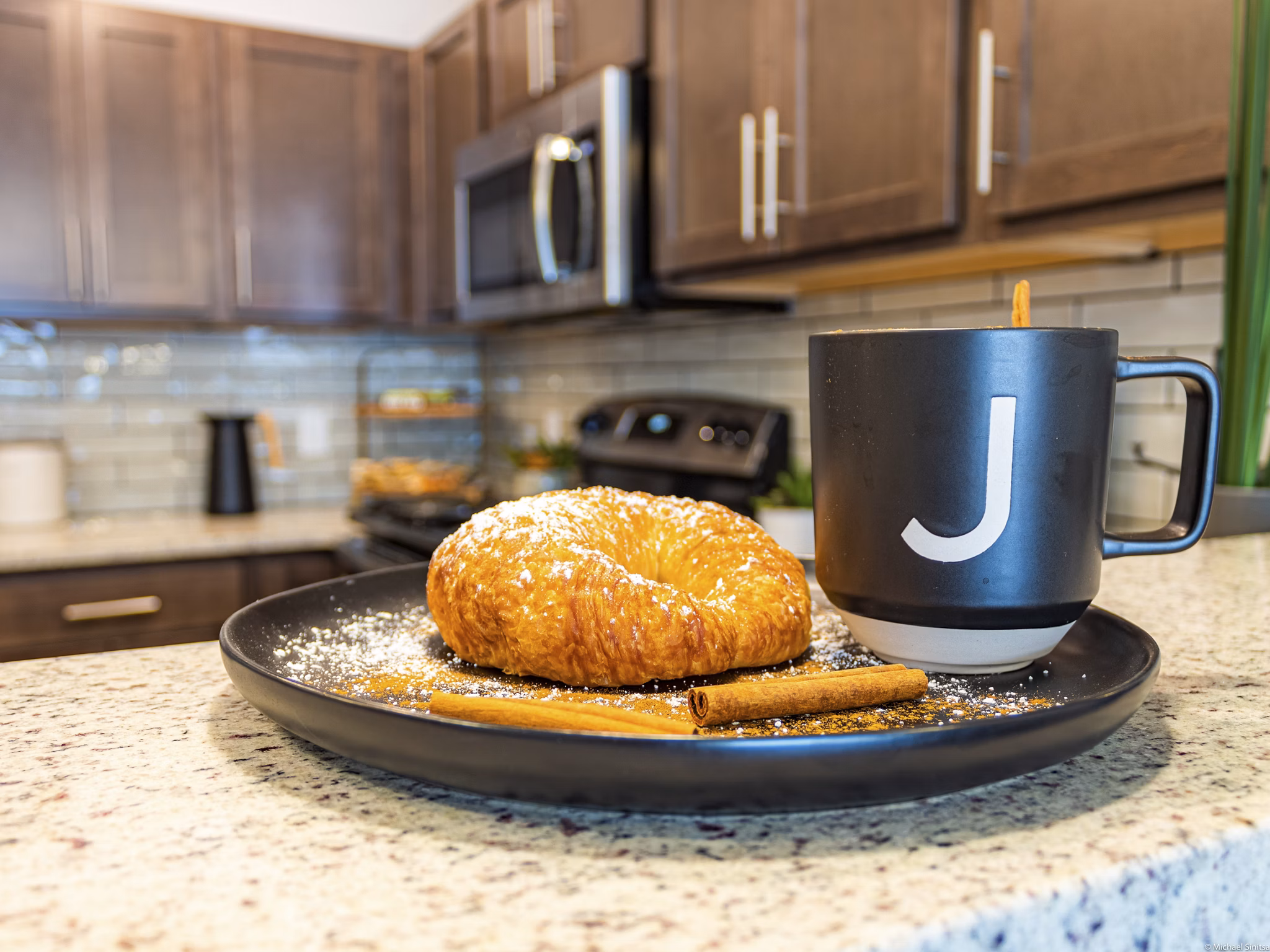 Modern kitchen with stainless steel appliances and granite countertops at Broadway190 Apartments