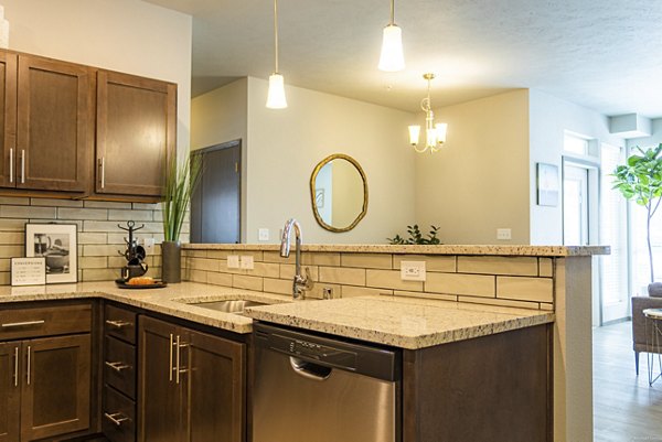 Modern kitchen with stainless steel appliances at Broadway190 Apartments, luxury living in vibrant city setting