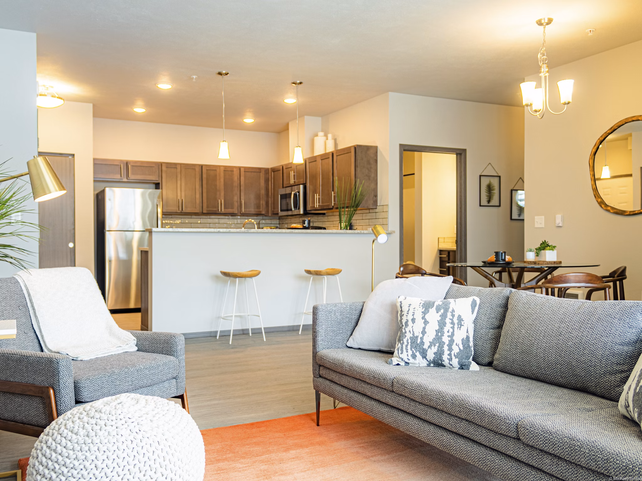 Living room with modern furnishings and large windows in Broadway190 Apartments