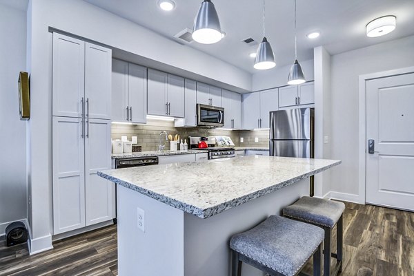 Modern kitchen with stainless steel appliances at The Jameson at Kincora Apartments
