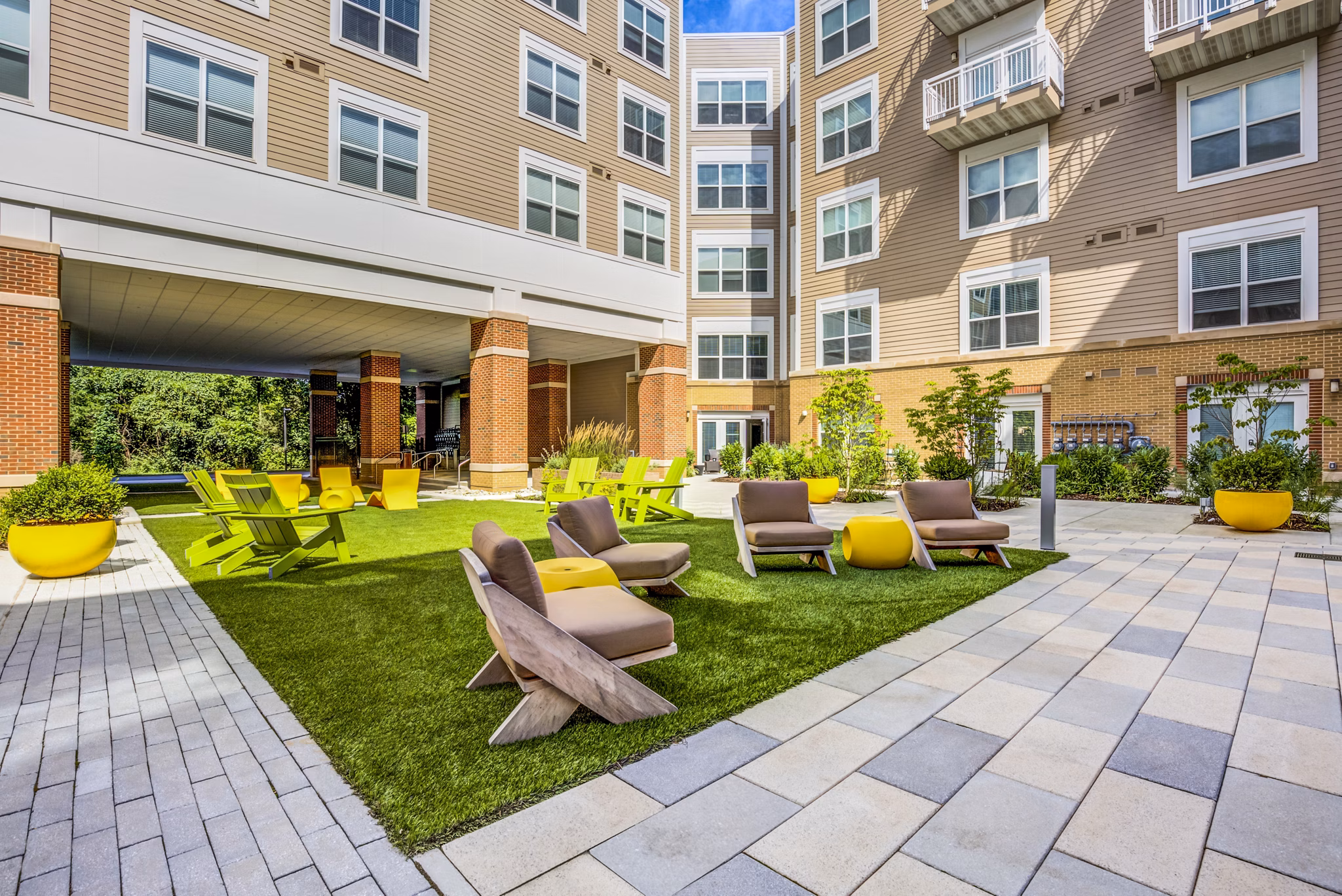 Patio with stylish furniture and landscaped garden at The Jameson at Kincora Apartments
