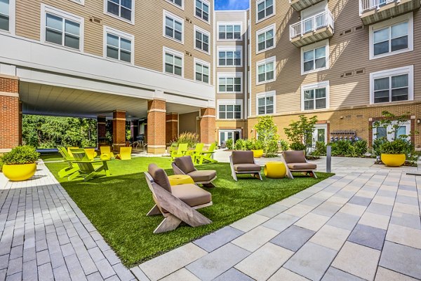 Patio with stylish furniture and landscaped garden at The Jameson at Kincora Apartments