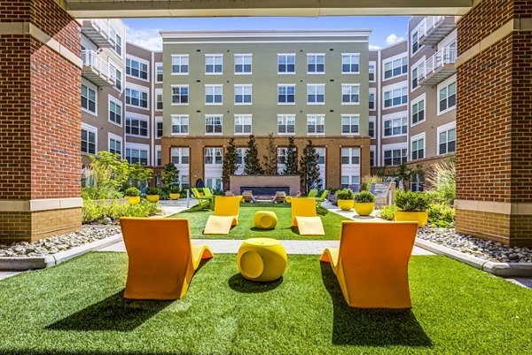 Spacious patio with stylish outdoor furniture at The Jameson at Kincora Apartments, perfect for relaxation and social gatherings
