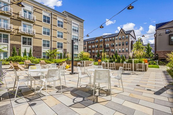 Cozy fire pit and patio area at The Jameson at Kincora Apartments, ideal for socializing and relaxation in a luxurious setting