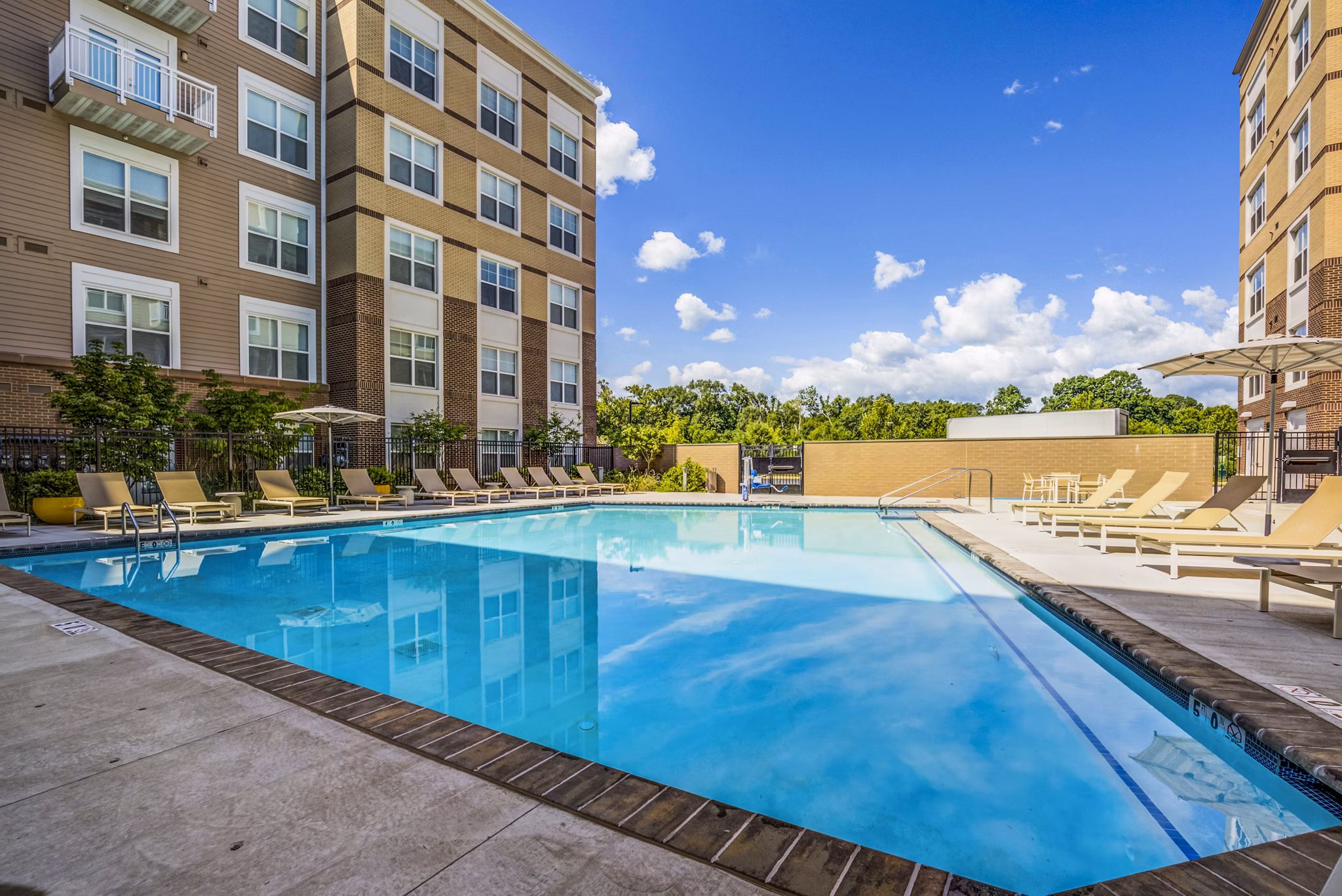Rooftop pool with lounge chairs at The Jameson at Kincora Apartments