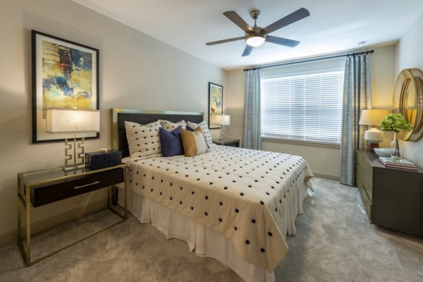 Bright bedroom with cozy furnishings at Domain Morgans Landing Apartments, ideal for luxury living