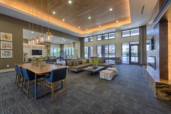 Modern clubhouse with comfortable seating and large windows at Domain Morgans Landing Apartments