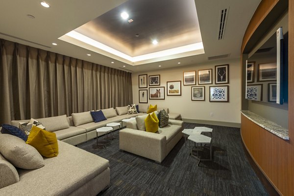 Domain Morgans Landing: Modern theater room with plush seating and large screen at luxury apartments