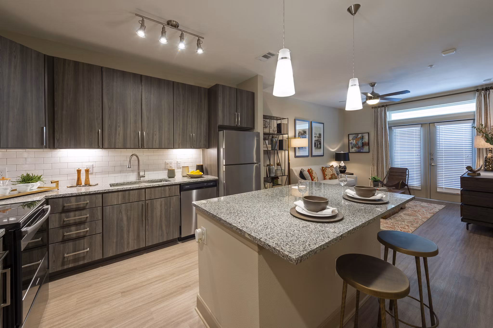 Modern kitchen with stainless steel appliances and granite countertops at Domain Morgans Landing Apartments