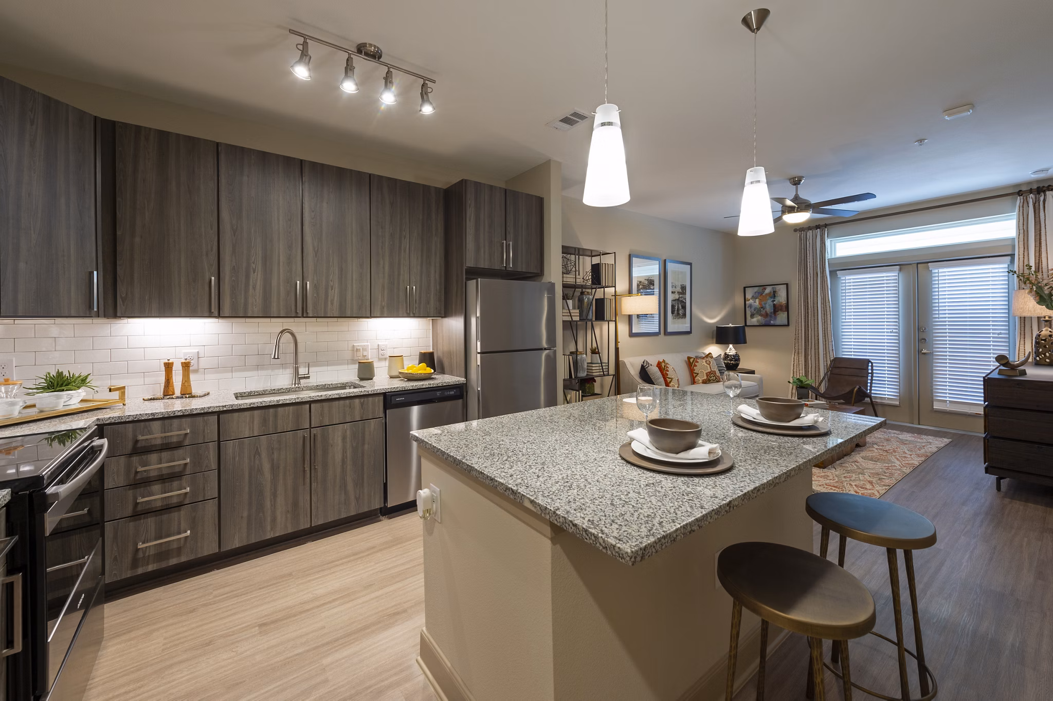 Modern kitchen with stainless steel appliances and granite countertops at Domain Morgans Landing Apartments