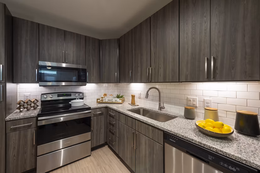 Modern kitchen with stainless steel appliances at Domain Morgans Landing Apartments