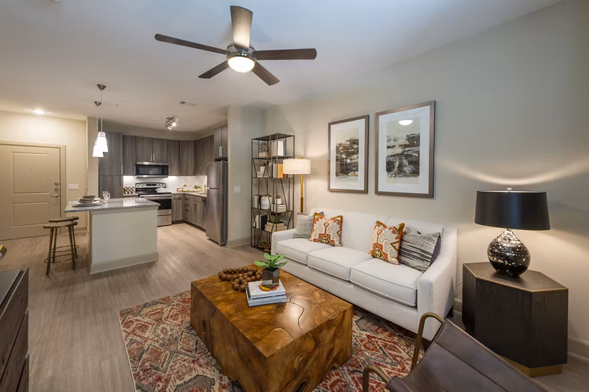 Spacious living room with modern decor and large windows at Domain Morgans Landing Apartments