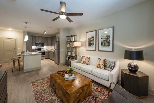 Spacious living room with modern decor and large windows at Domain Morgans Landing Apartments