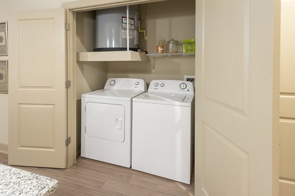 Laundry room with energy-efficient washers and dryers at Domain Morgans Landing Apartments, a Greystar property