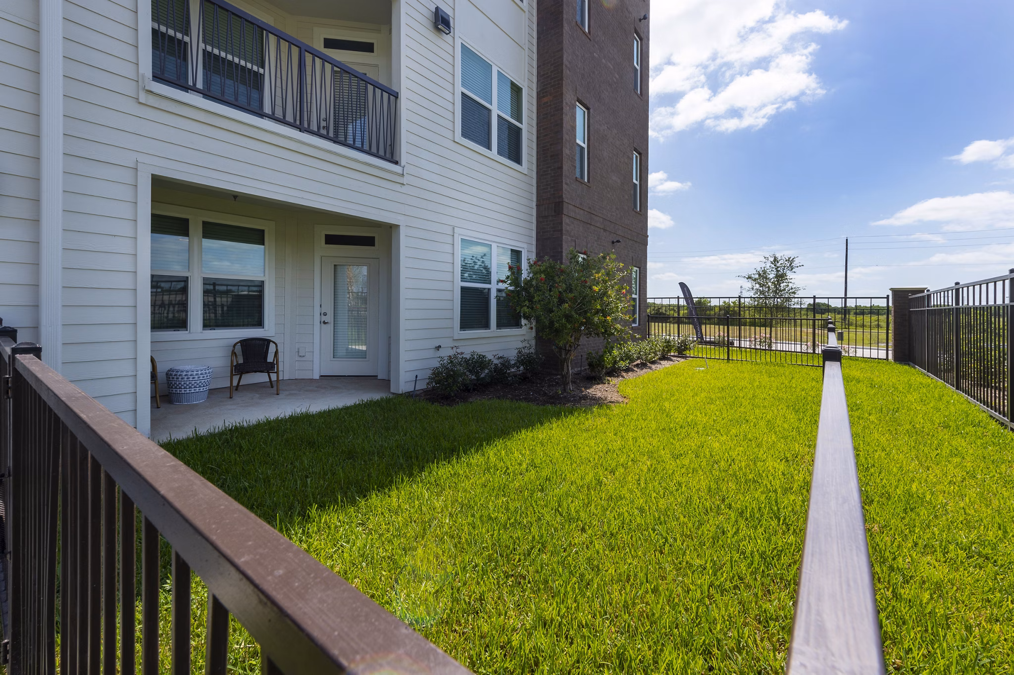 Spacious outdoor patio with modern seating at Domain Morgans Landing Apartments, ideal for relaxation and social gatherings