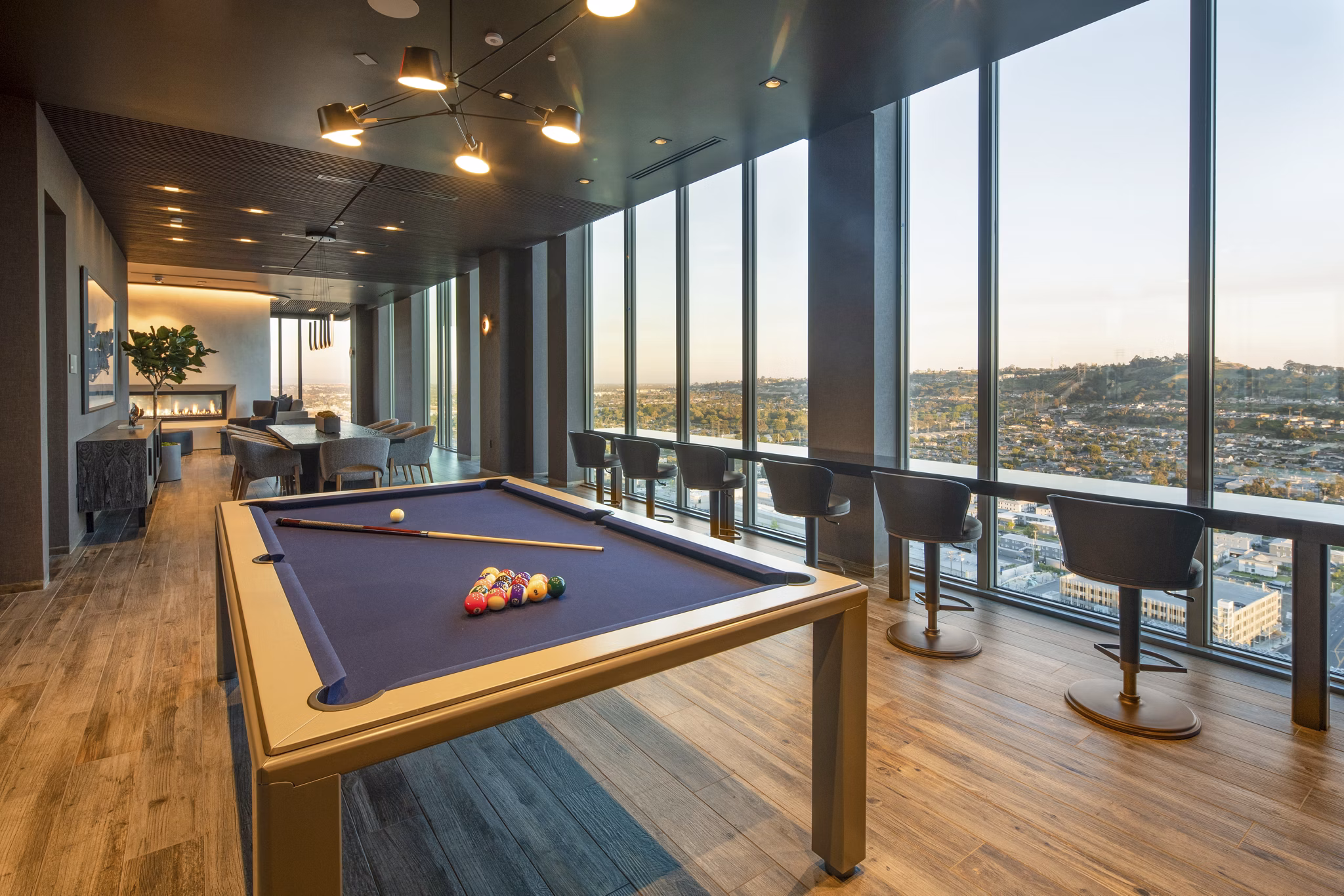Vibrant game room with billiards table and seating area at ARQ Apartments, perfect for resident entertainment and relaxation