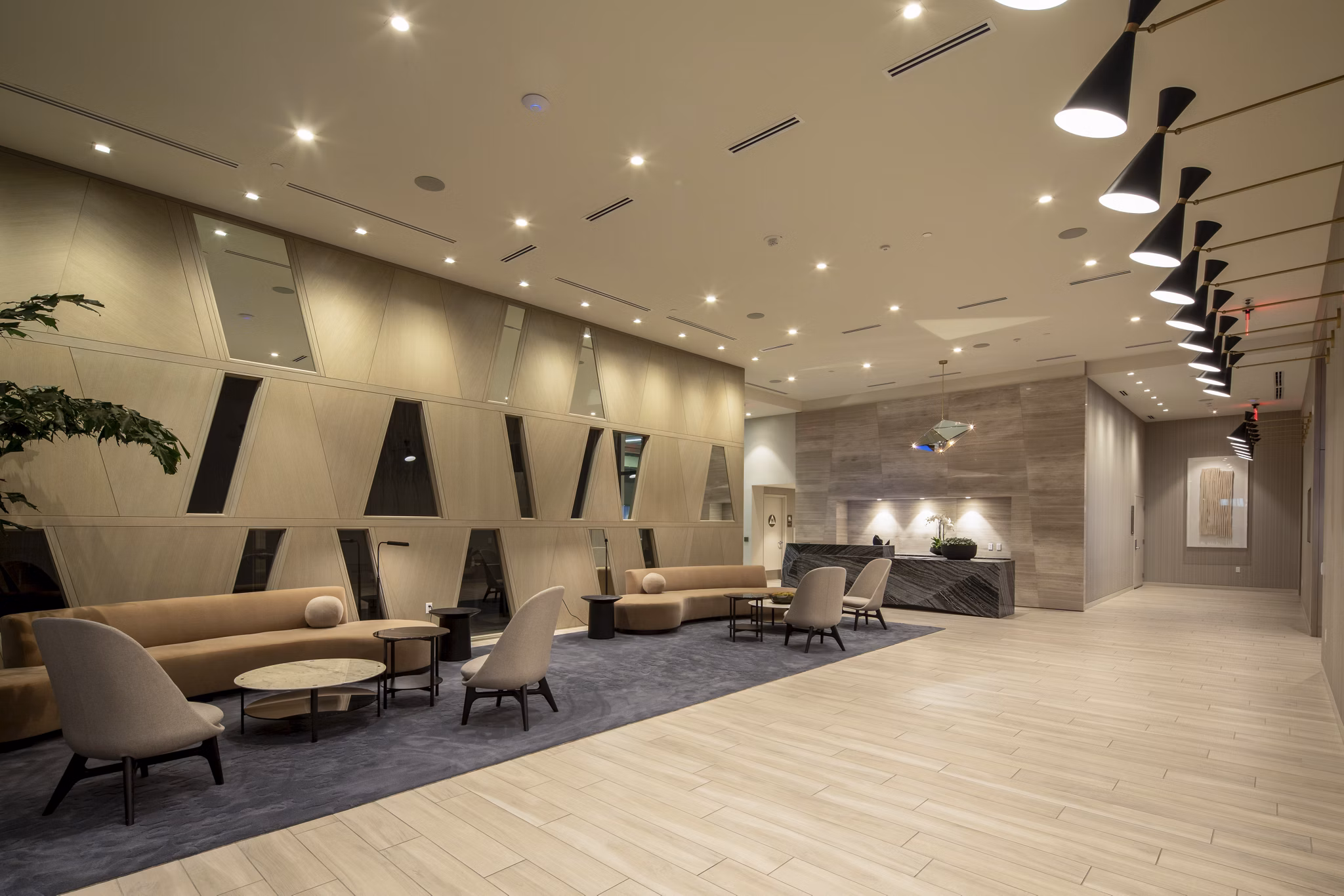 Clubhouse featuring modern seating and entertainment space at ARQ Apartments
