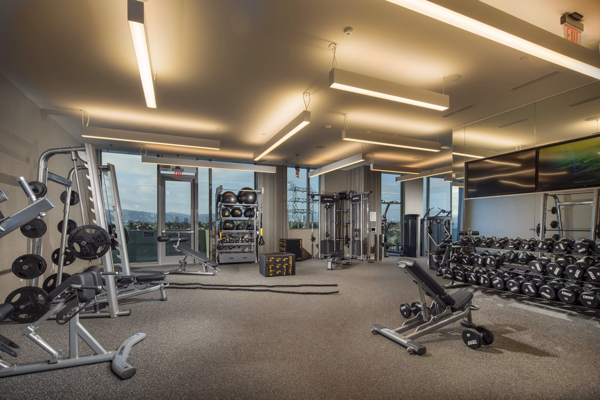 Modern fitness center with state-of-the-art equipment at ARQ Apartments