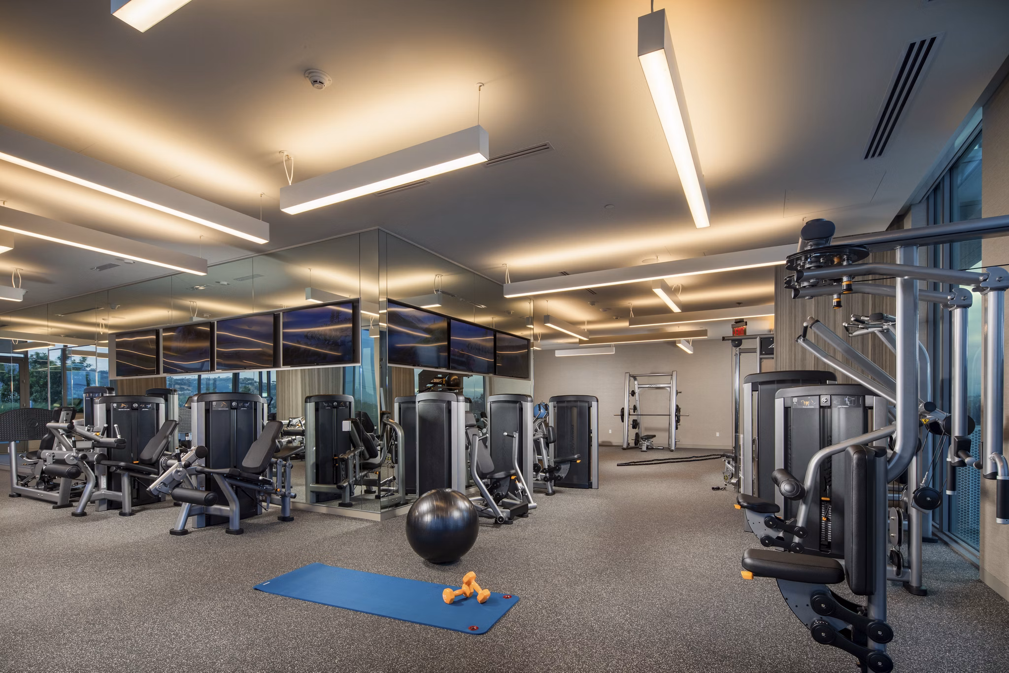 Modern fitness center with state-of-the-art equipment at ARQ Apartments for an active lifestyle