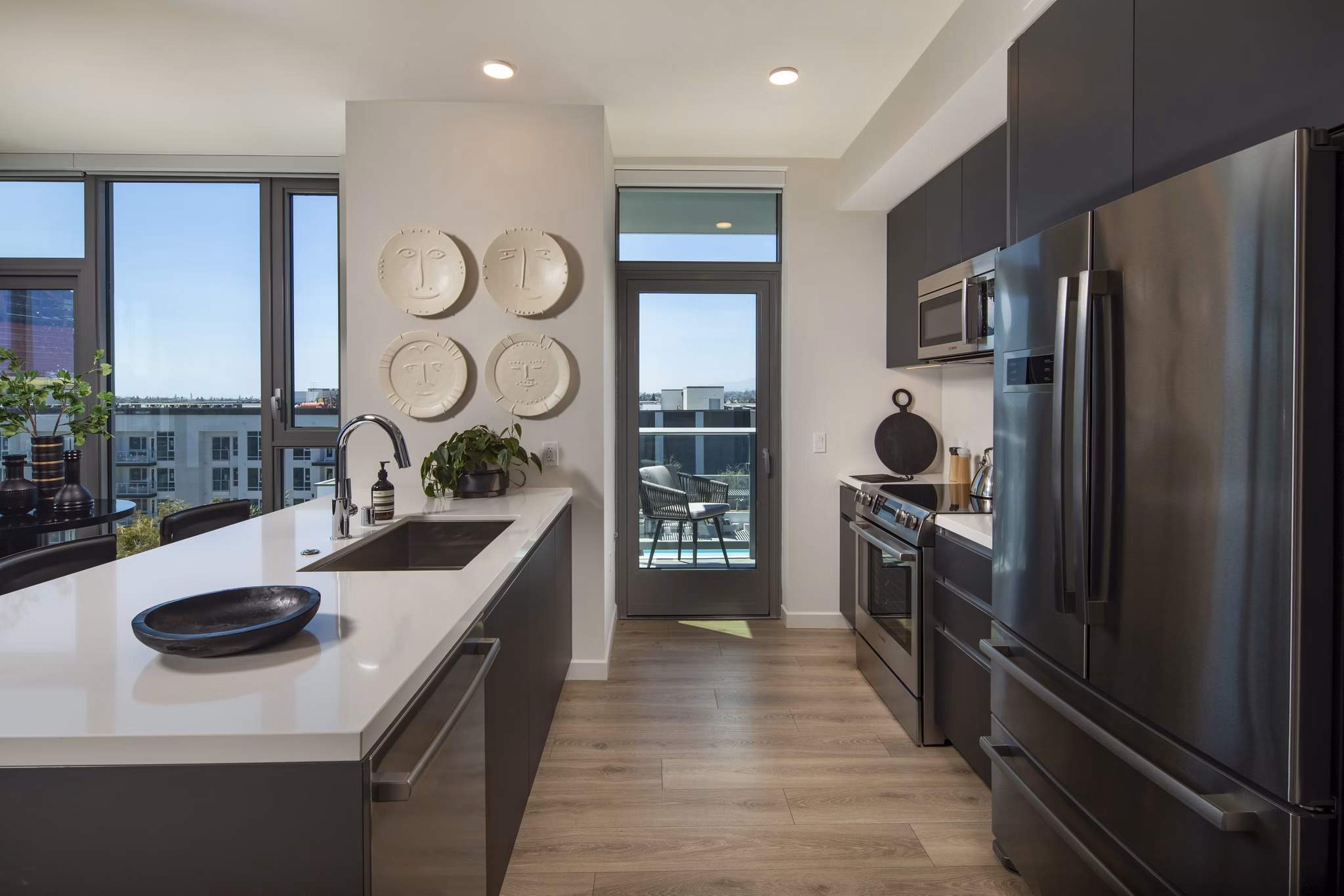 Modern kitchen with stainless steel appliances in ARQ Apartments, offering luxury living in a beautifully designed space