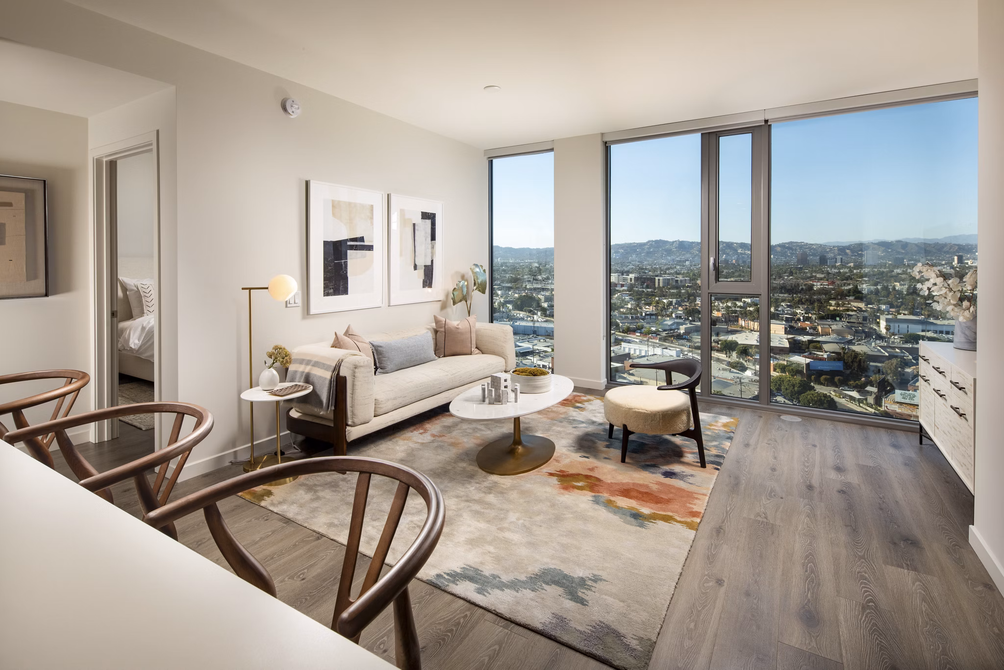 Spacious living room with modern decor and large windows in ARQ Apartments, offering luxury living experience