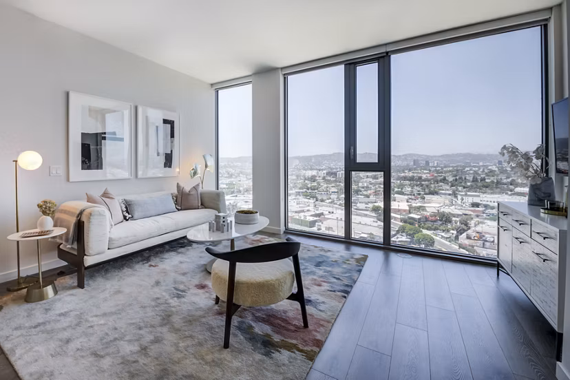 Spacious living room with chic dÃ©cor and natural light at ARQ Apartments, offering a luxurious lifestyle