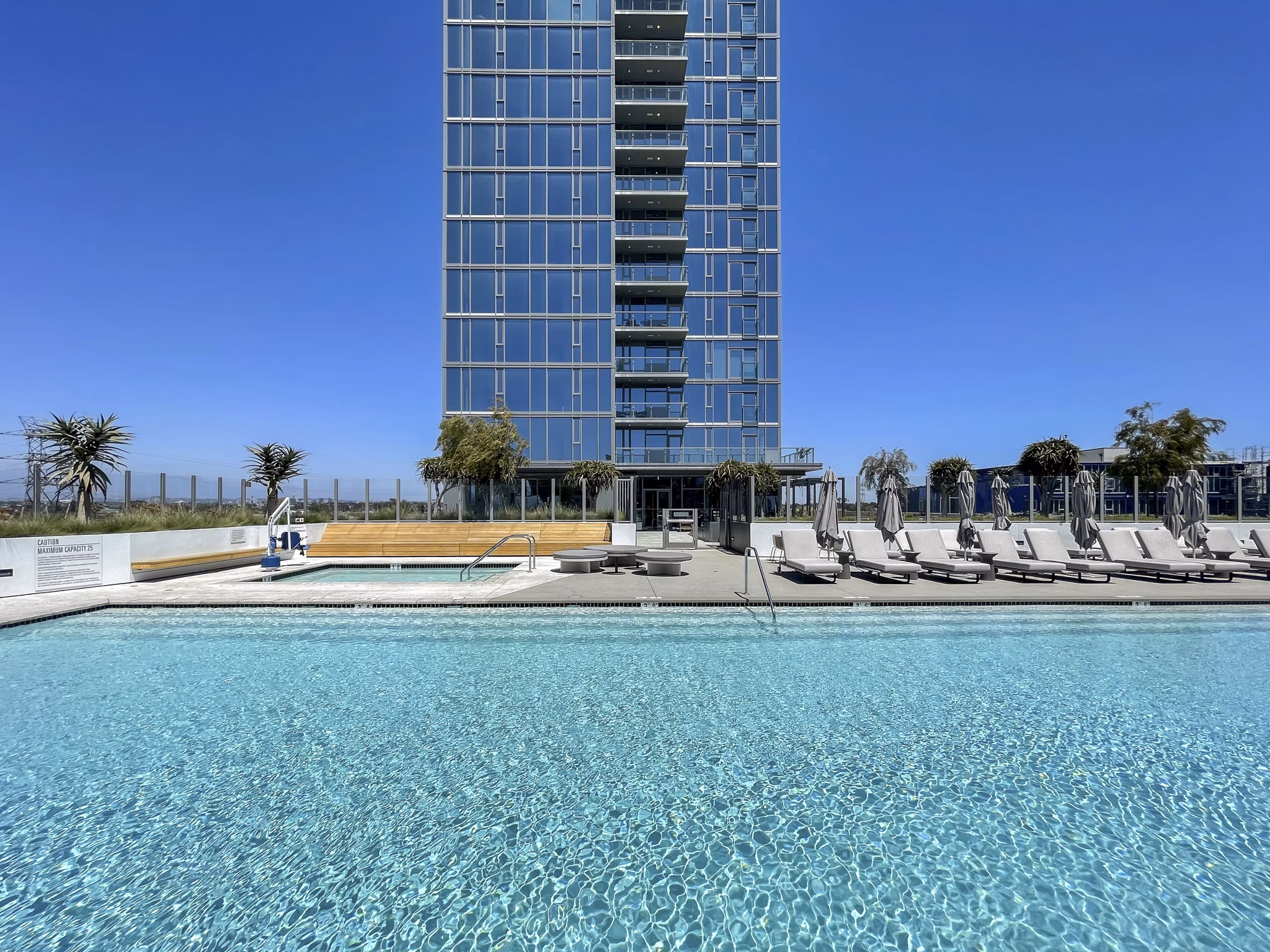 Stunning rooftop pool with skyline views at ARQ Apartments, luxury living by Greystar