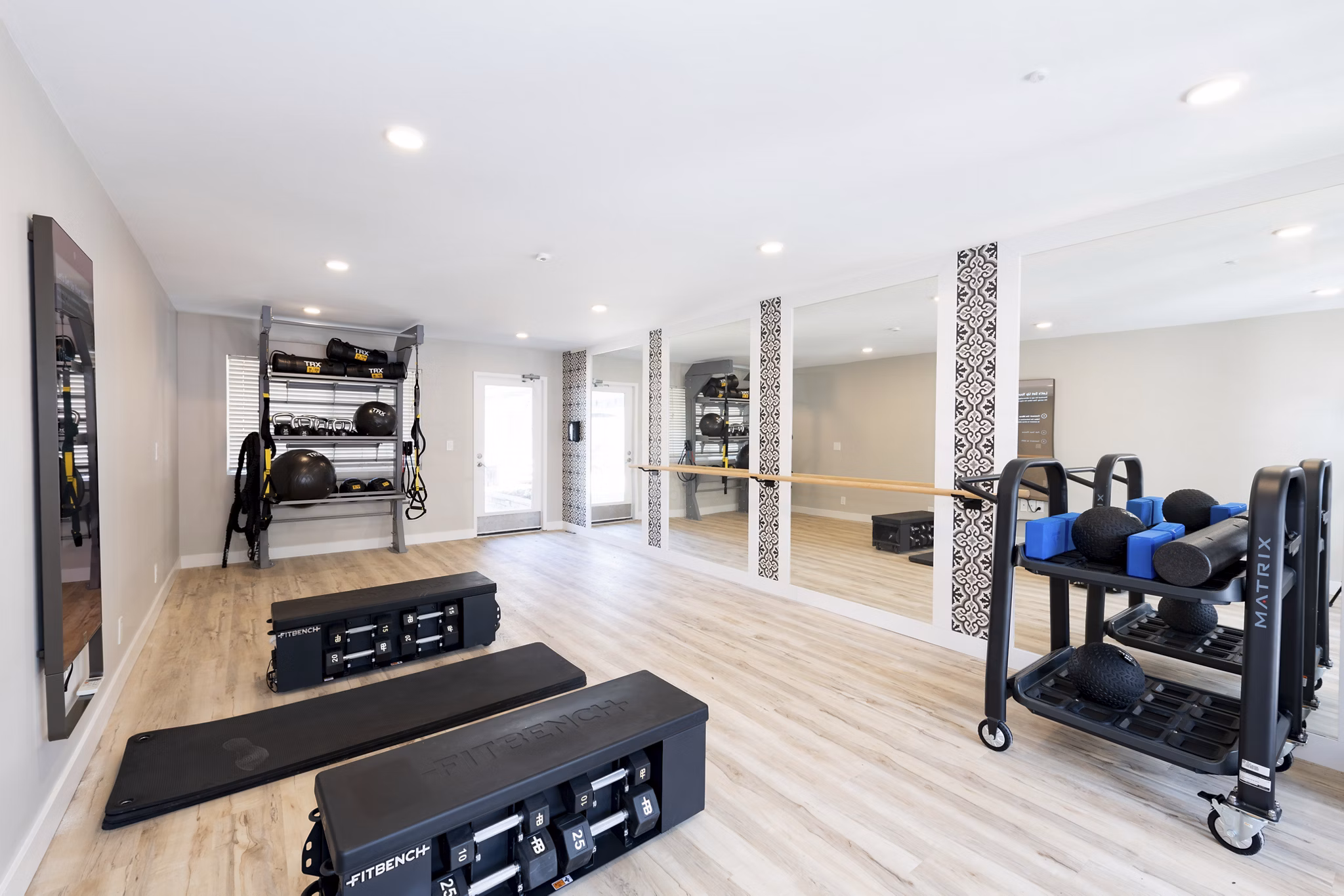 Well-equipped fitness center at Oak & Iron apartments featuring state-of-the-art exercise machines and spacious workout area