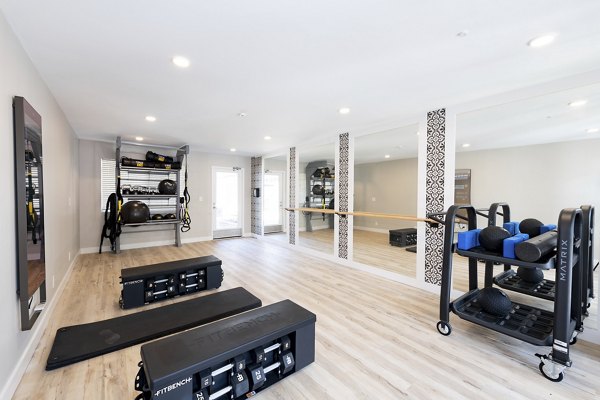 Well-equipped fitness center at Oak & Iron apartments featuring state-of-the-art exercise machines and spacious workout area
