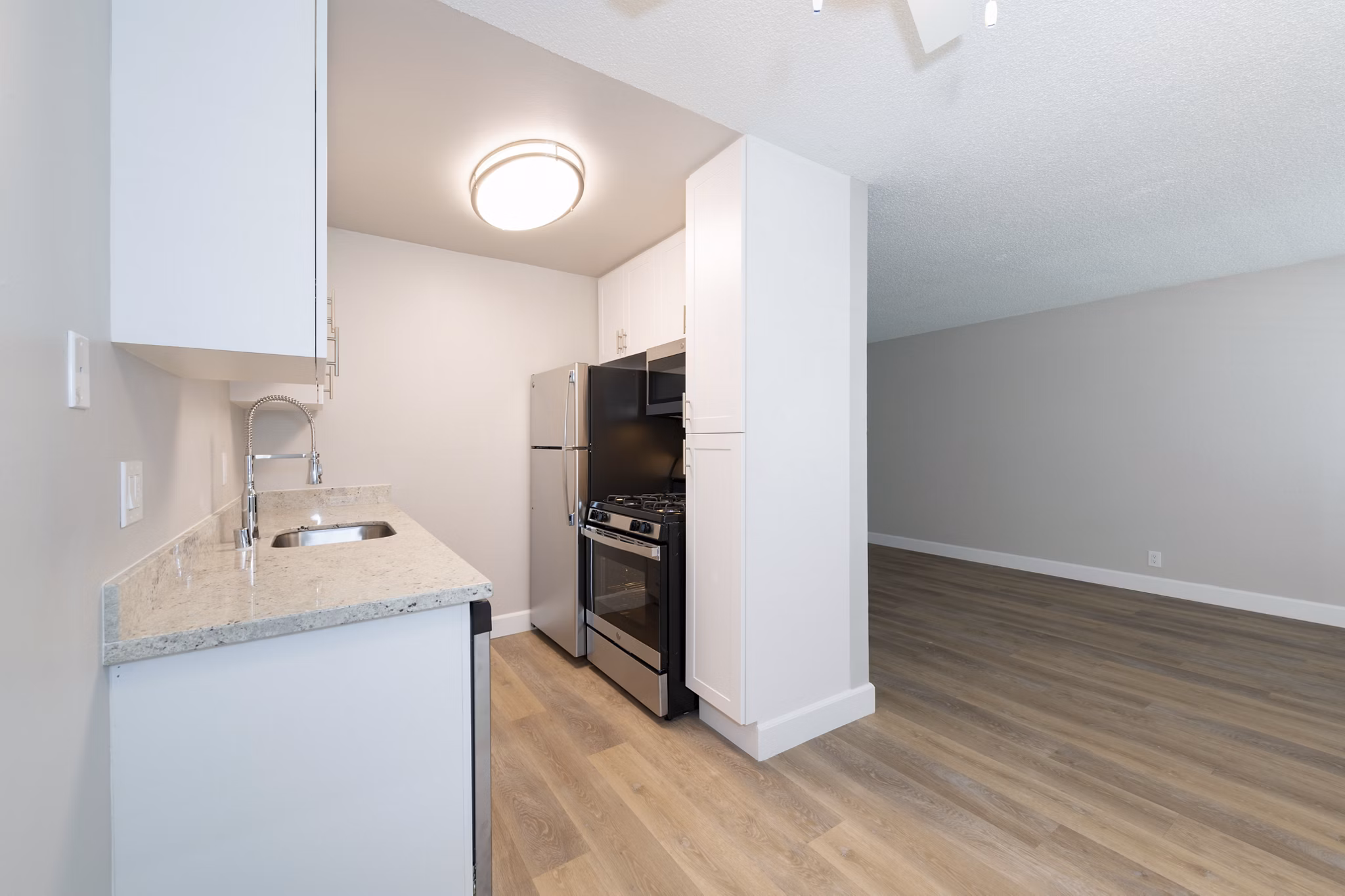 Modern kitchen with sleek countertops and stainless steel appliances in Oak & Iron luxury apartments