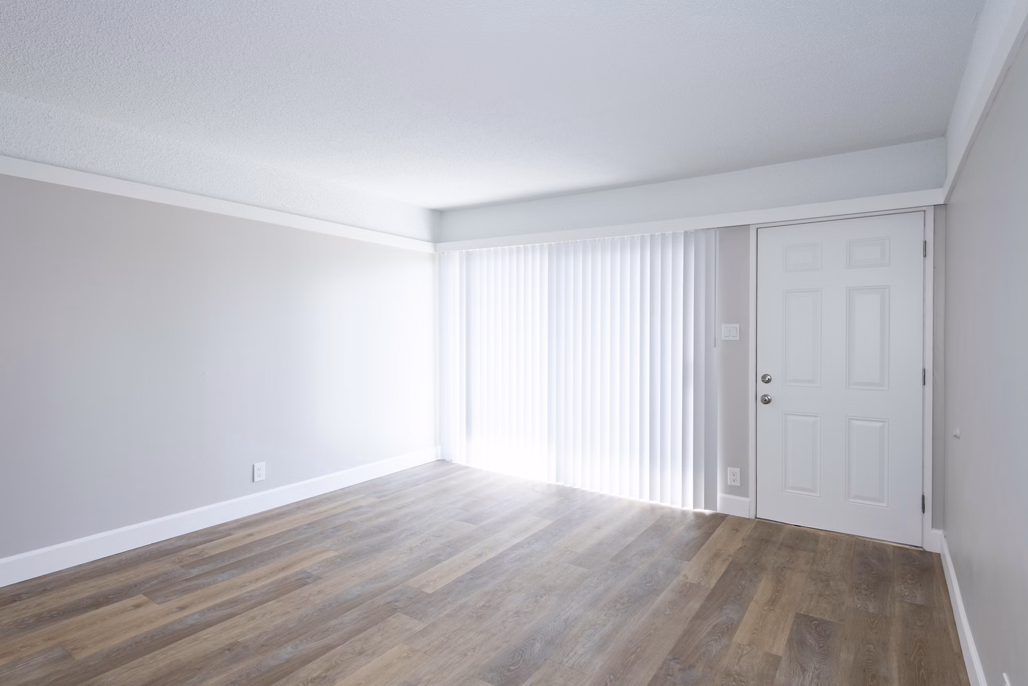 Living room with modern furnishings and natural light at Oak & Iron luxury apartments