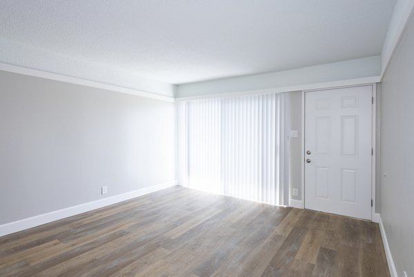 Living room with modern furnishings and natural light at Oak & Iron luxury apartments