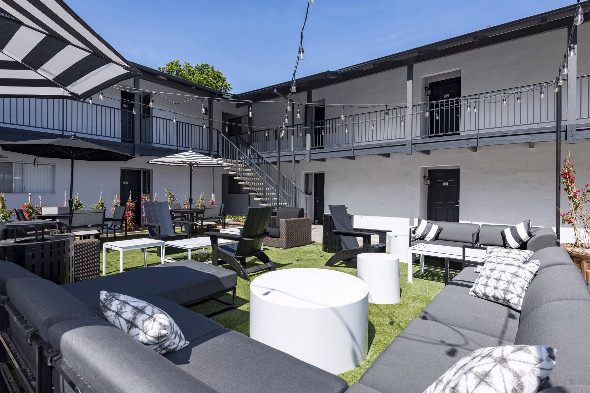 Oak & Iron: Tranquil courtyard at luxury apartments featuring landscaped greenery and seating areas