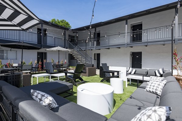 Oak & Iron: Tranquil courtyard at luxury apartments featuring landscaped greenery and seating areas
