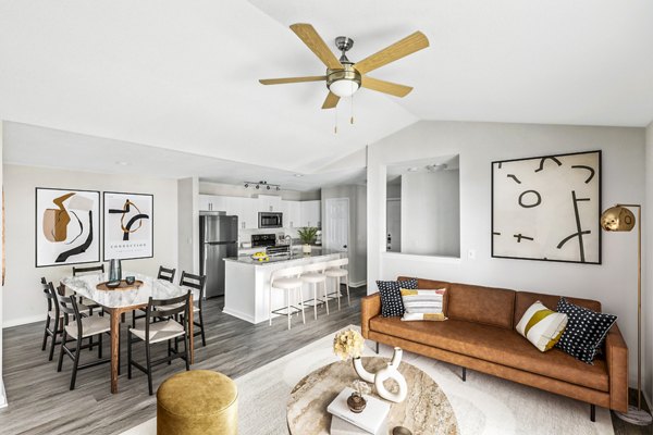 Spacious living room at Banyan Grove Apartments featuring modern decor and large windows, offering comfort in a stylish setting