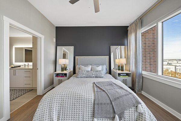 Cozy bedroom with modern furnishings at Element SouthPark Apartments in Charlotte