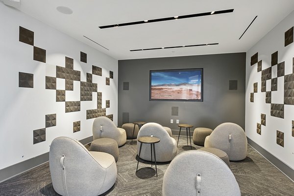 Modern clubhouse theater with plush seating at Element SouthPark Apartments offering luxury entertainment for residents