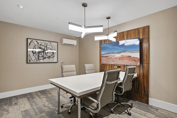 Modern meeting facility at Element SouthPark Apartments with flexible seating and conference technology, ideal for gatherings in luxury setting