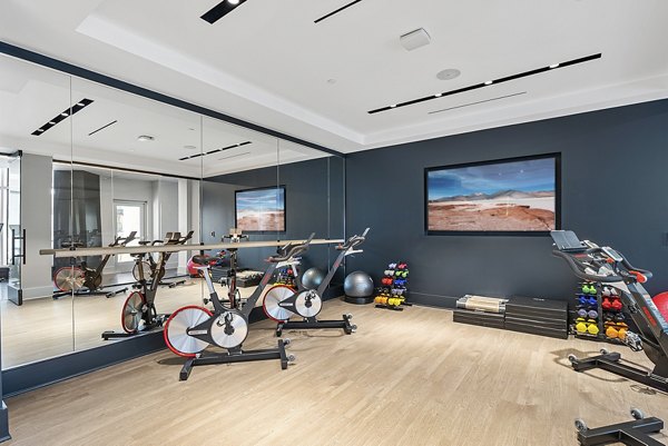 Bright yoga/spin studio with mirrored walls and exercise bikes at Element SouthPark Apartments, Charlotte