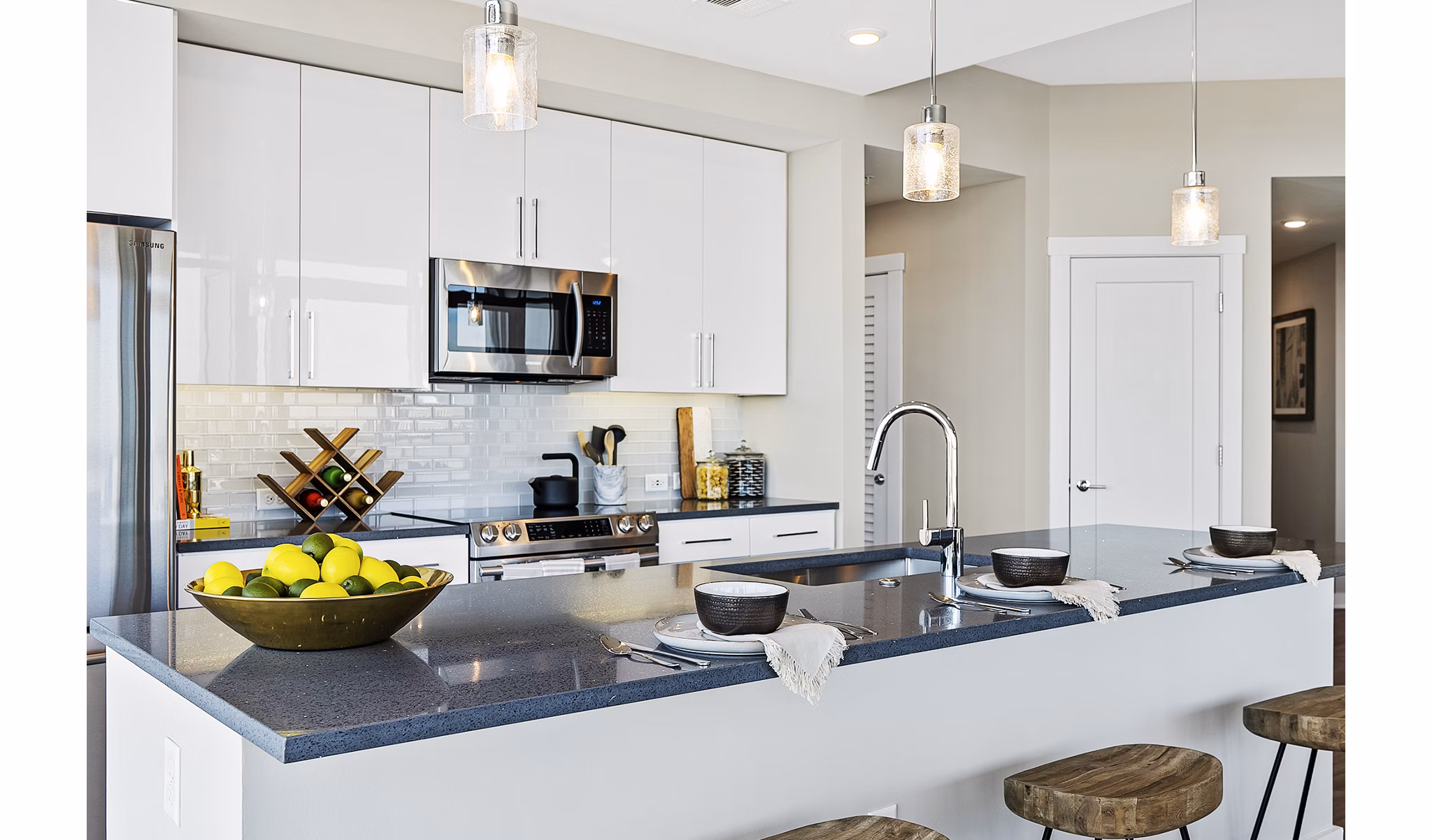 Modern kitchen with stainless steel appliances and granite countertops at Element SouthPark Apartments