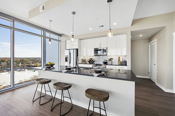 Modern kitchen with stainless steel appliances at Element SouthPark Apartments
